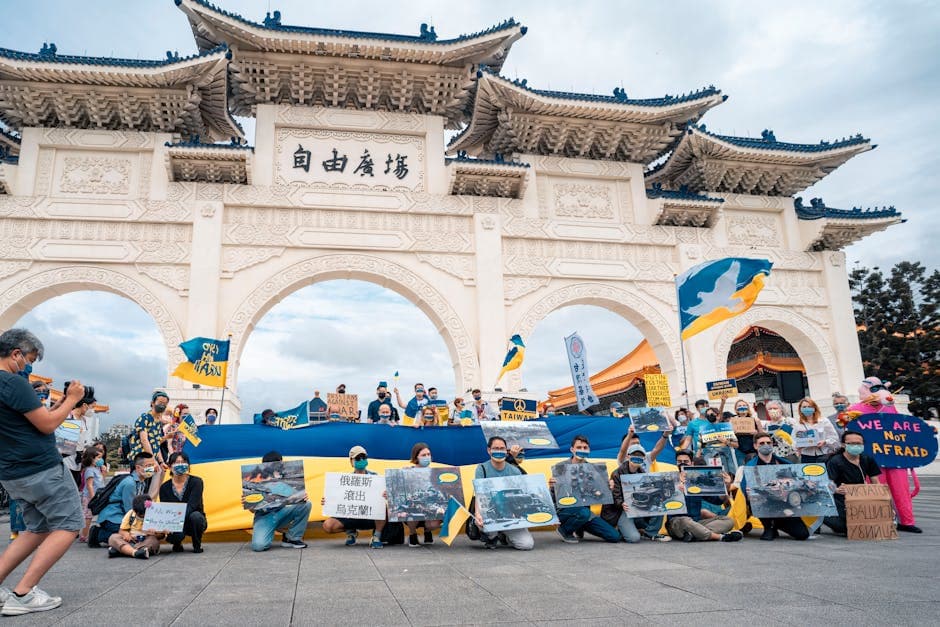 Protesters gather with Ukrainian flags at Liberty Square, advocating for peace and democracy.