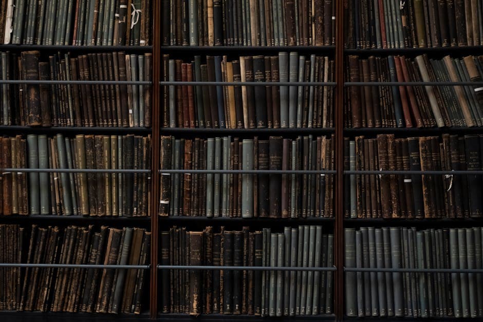 A close-up of vintage books on library shelves in London, showcasing an abundance of literary history.
