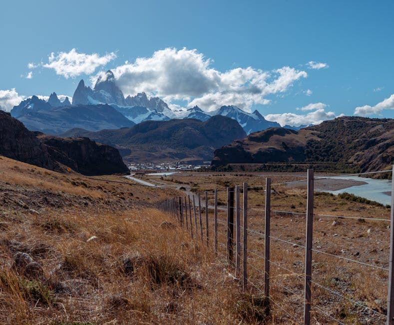 Explore the stunning Patagonian landscape with mountains, river, and rural charm.