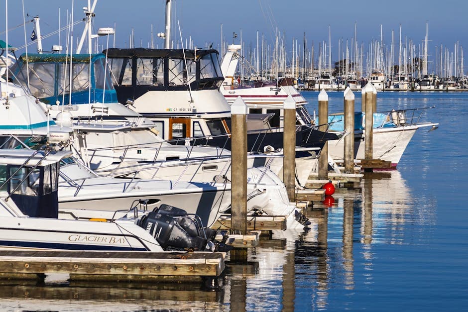 A picturesque view of yachts and boats moored at a marina with clear blue skies.