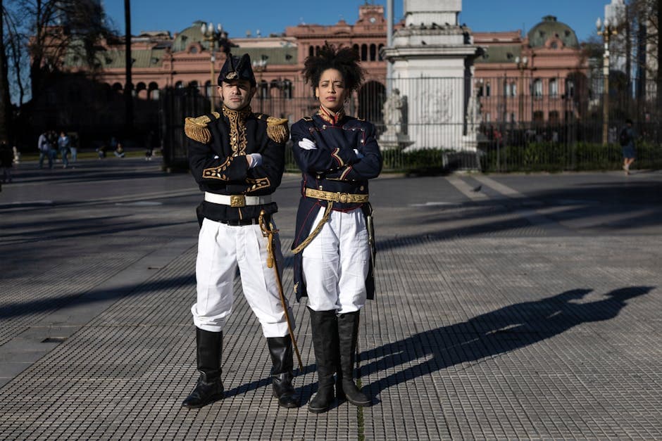 Two ceremonial guards in traditional uniforms stand at Casa Rosada, Buenos Aires.