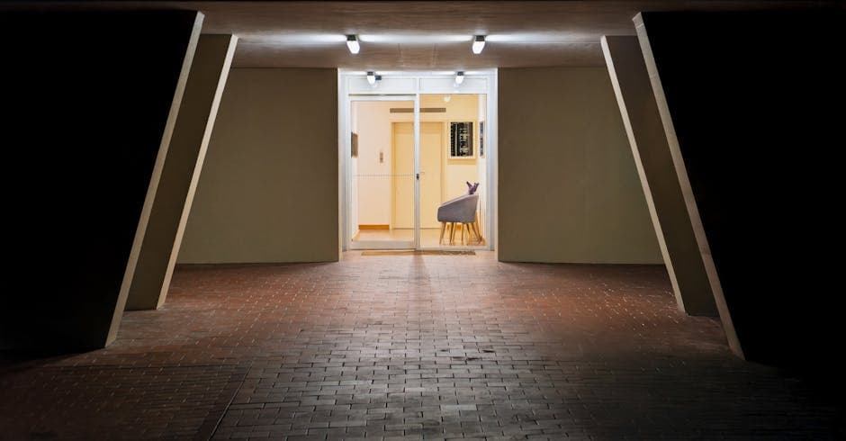 A contemporary building entrance in Hobart, Tasmania, illuminated at night.