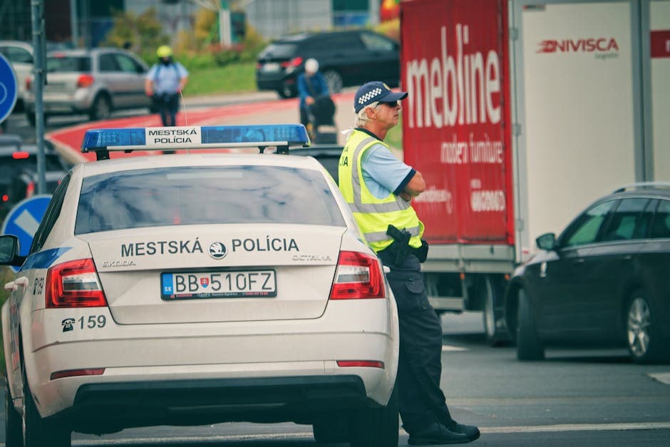 Police officer managing traffic on a city street in Slovakia.