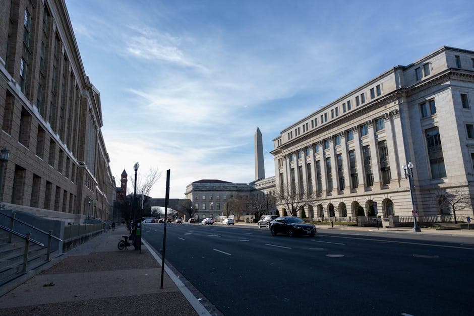 Street view in Washington DC featuring historic buildings and the Washington Monument.