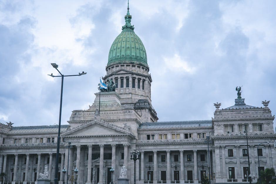 Upward view of the iconic National Congress building in Buenos Aires with cloudy sky.