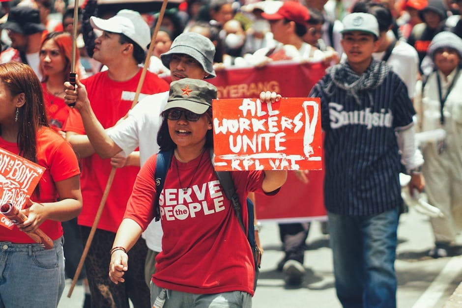 Crowd of diverse protesters during a workers' rights demonstration in the city.