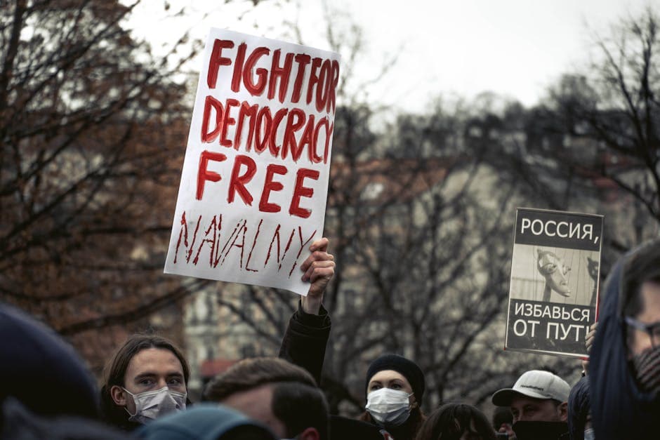 Demonstrators in Prague holding signs advocating for political change and democracy.