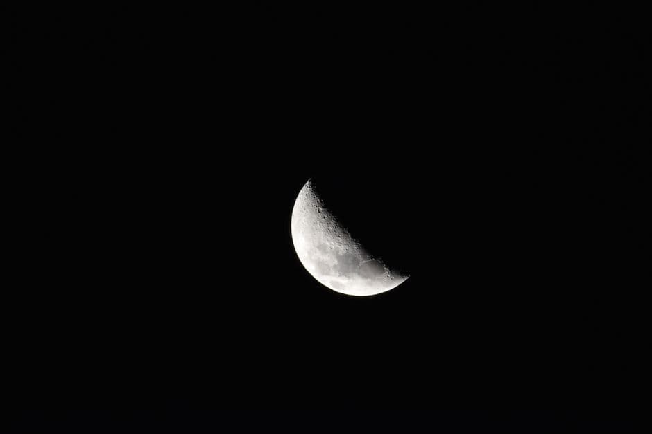 Beautiful crescent moon captured in clear night sky over Lima, Peru.
