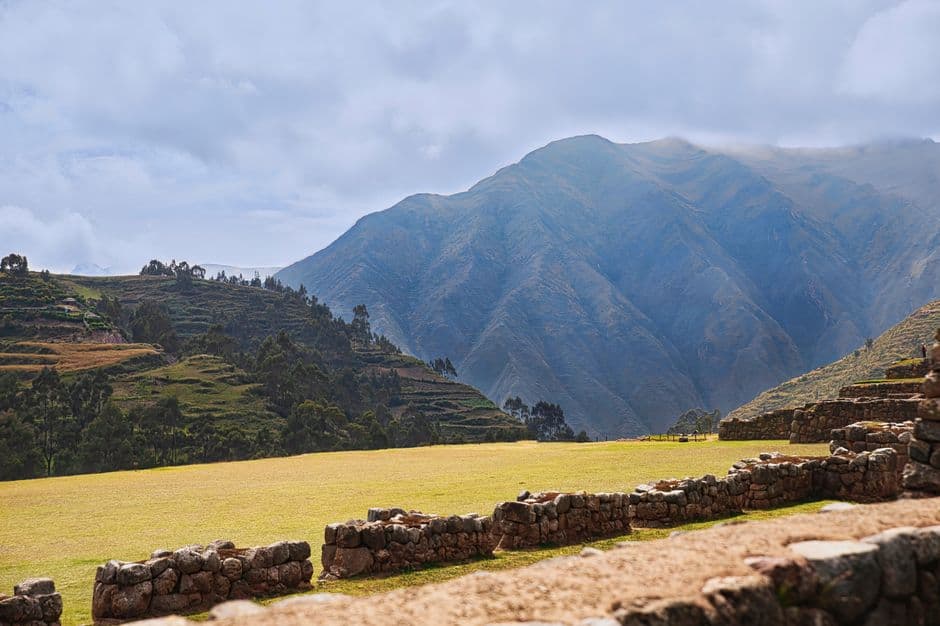 Beautiful mountain scenery with ancient stone ruins under a cloudy sky.