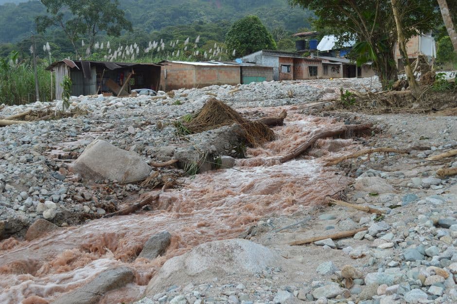 Aftermath of a flood in rural Mocoa, Colombia, showing debris and destruction.