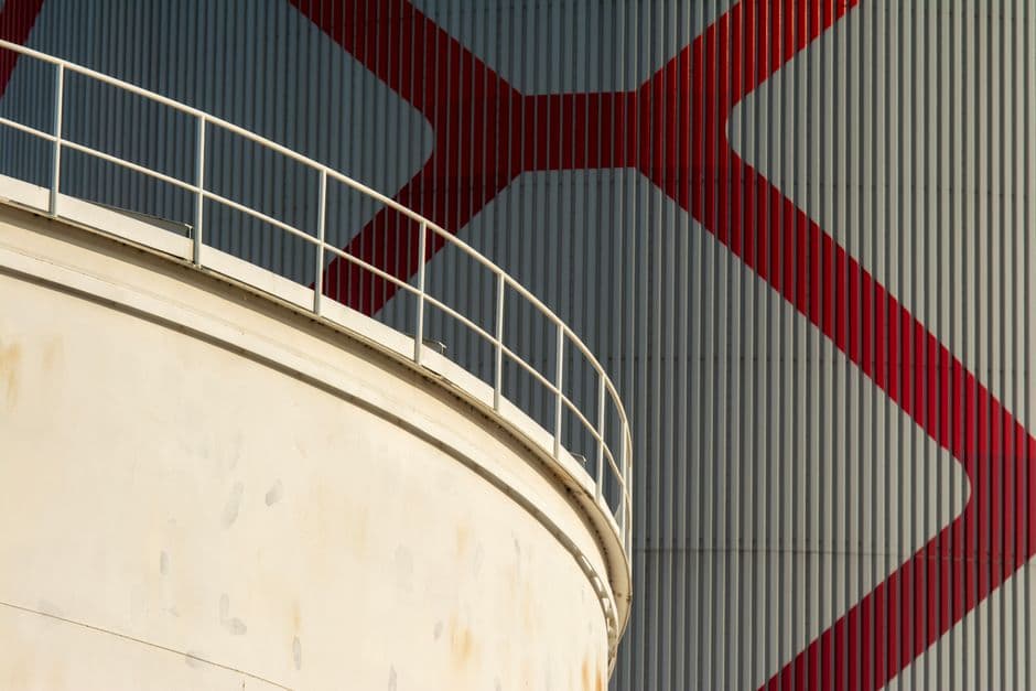 Low angle view of modern architectural structure with bold geometric patterns on a sunny day.