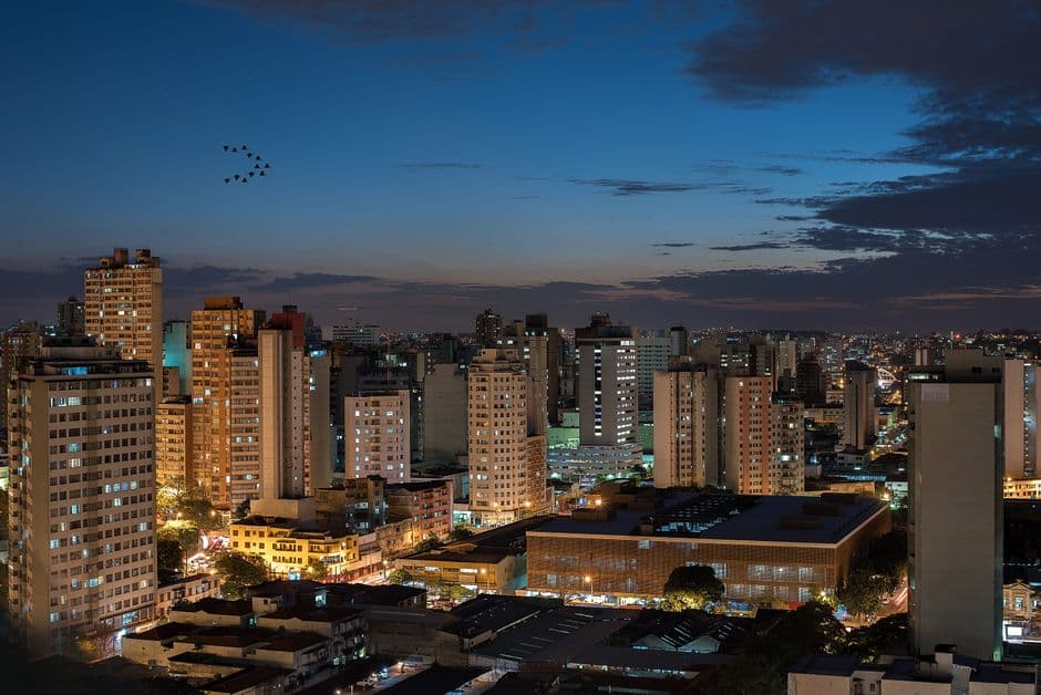 Aerial view of illuminated buildings in Belo Horizonte, Brazil, at dusk.