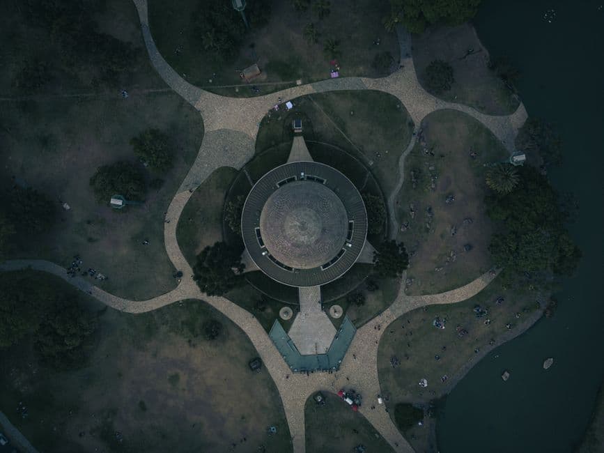 Drone shot of a circular pavilion in Buenos Aires park showcasing modern architecture and pathways.
