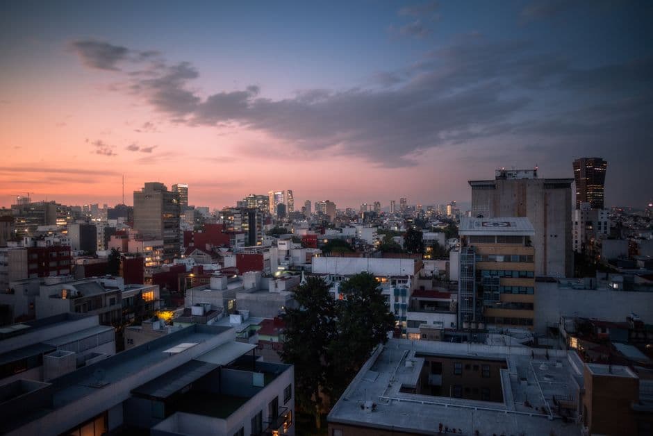 Captivating aerial view of Mexico City's urban skyline during sunset, showcasing vibrant cityscape.