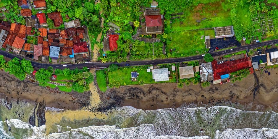 Vibrant aerial view of Cisolok, West Java, showcasing coastline and colorful houses.