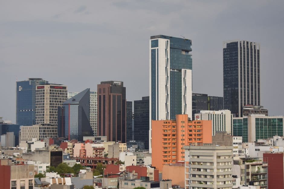 A modern skyline view of Mexico City featuring high-rise skyscrapers and urban architecture.