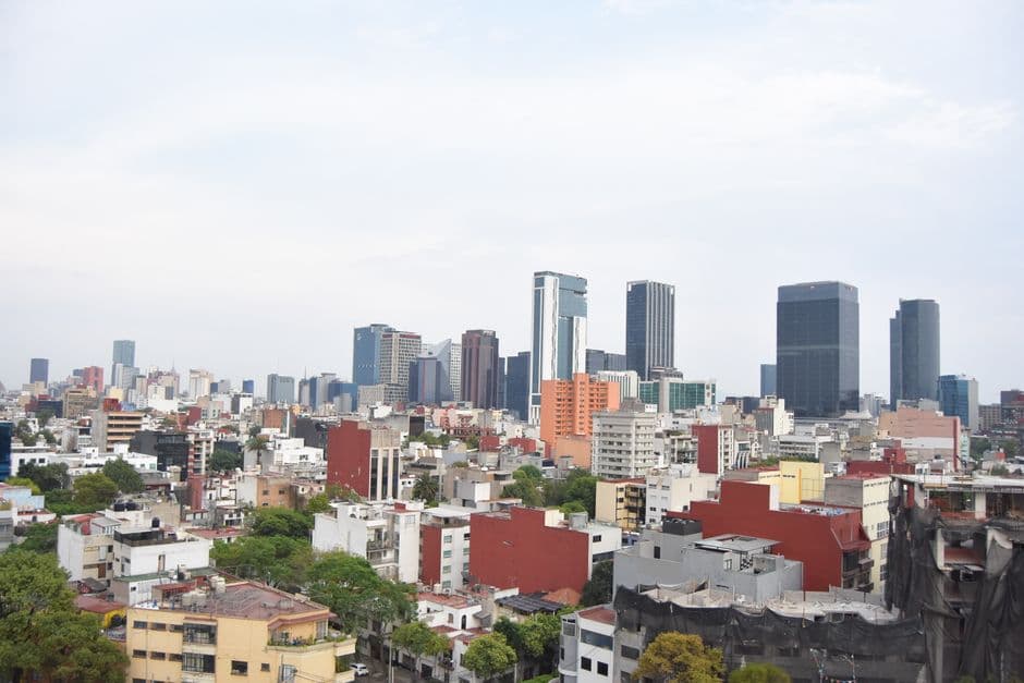 Aerial skyline view of Mexico City's modern skyscrapers and urban landscape.