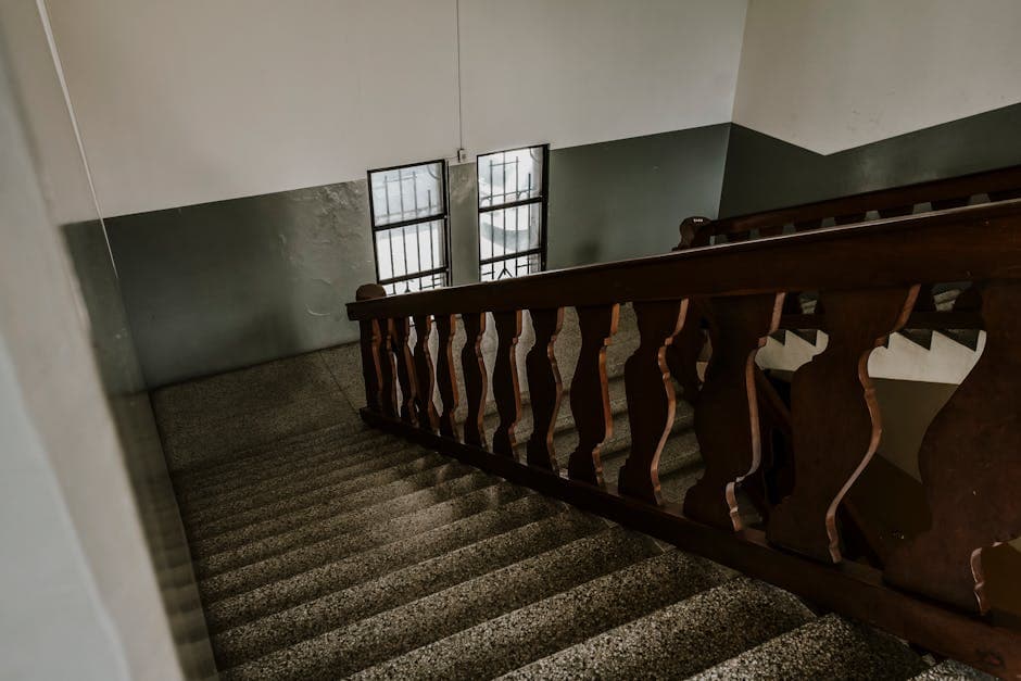 High angle view of a vintage staircase with wooden handrail in Mérida, Venezuela.