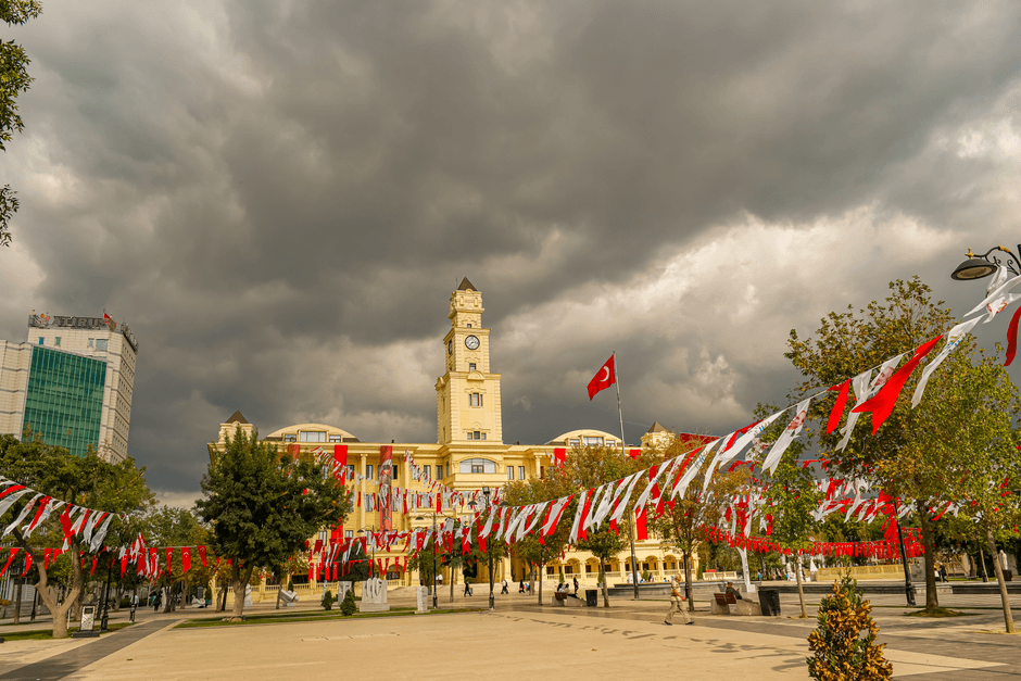 Büyükçekmece City Hall adorned with Turkish flags under a cloudy sky in Istanbul, Turkey.