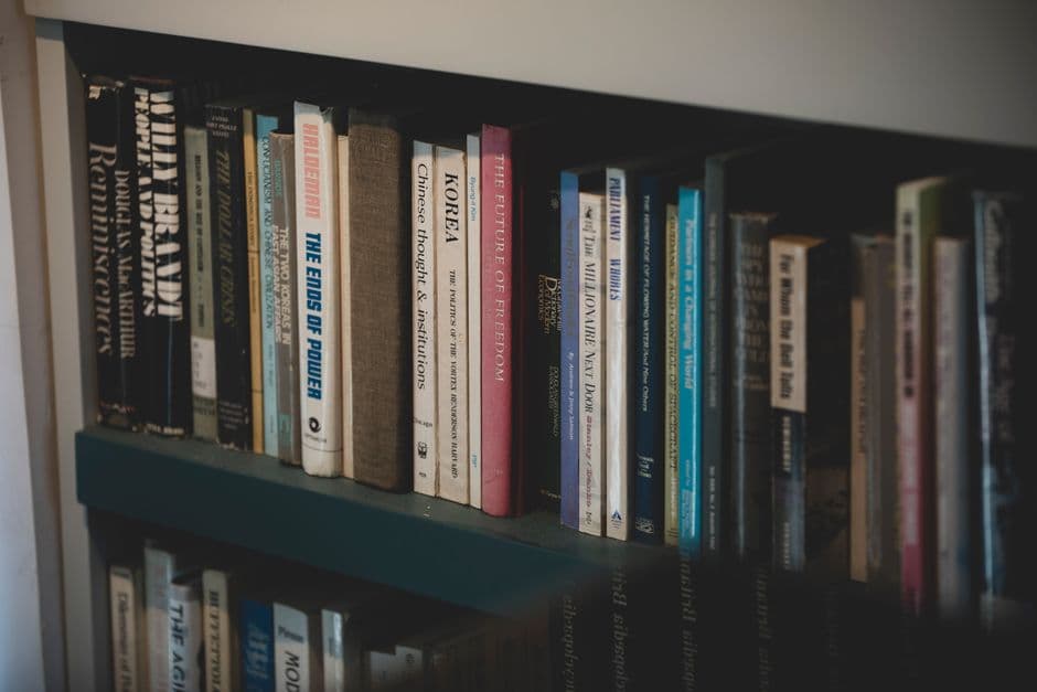 A close-up of a bookshelf filled with diverse books on various subjects, ideal for education and study.