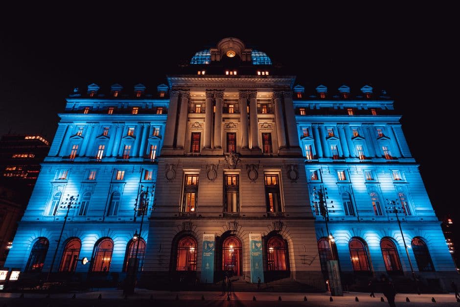 Explore the stunning illuminated landmark in Buenos Aires, showcasing modern architecture against a night sky.