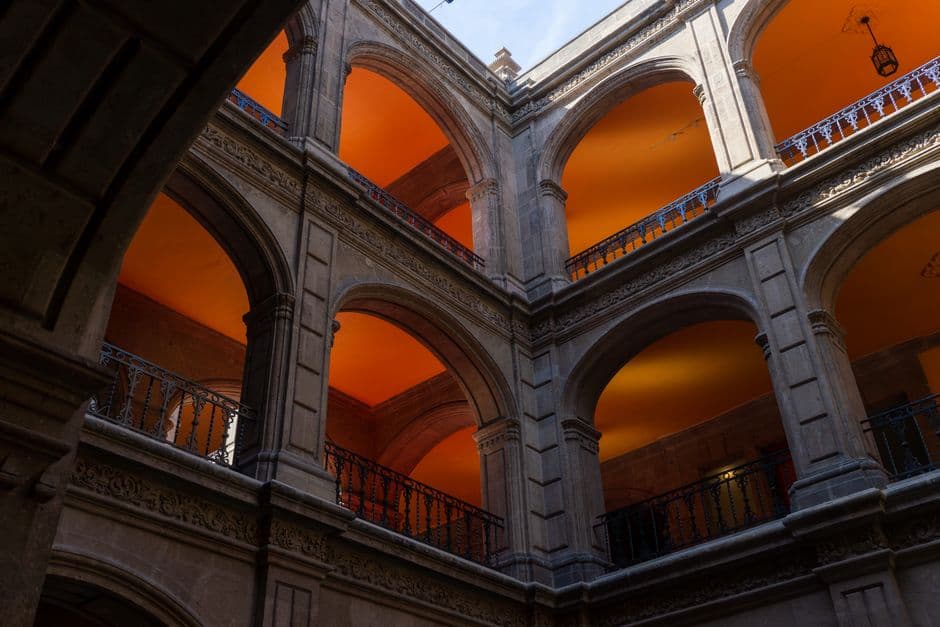 Explore the stunning arches of a historic building in Mexico City, showcasing exquisite architecture.