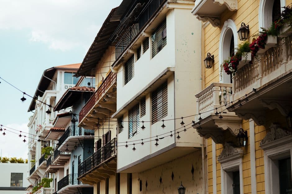 Beautiful urban residential buildings with balconies and hanging lights, showcasing classic architecture.