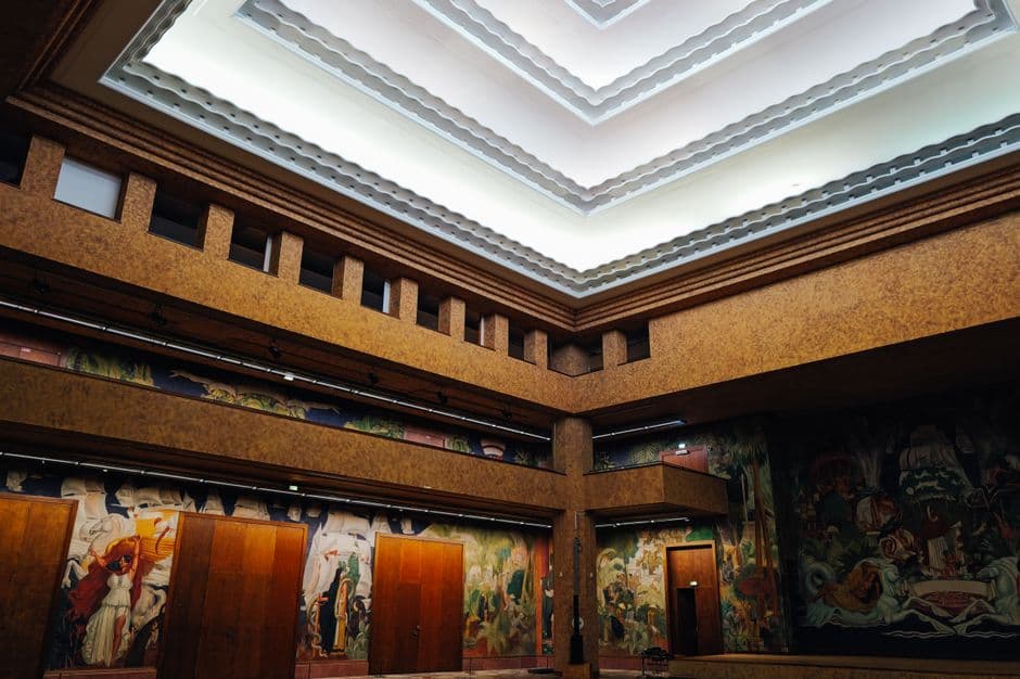 Explore the artistic interior featuring vibrant murals in a historic building.