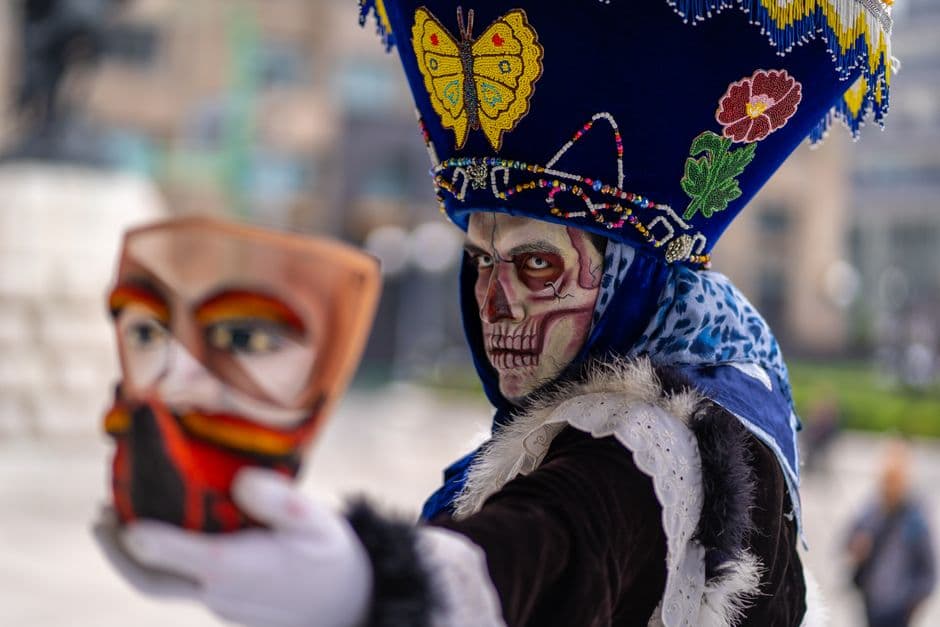 Colorful Day of the Dead costume with calavera makeup in Mexico City.