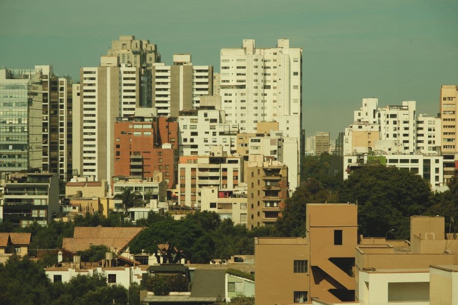 Cityscape featuring a skyline of tall, modern buildings against a clear sky.