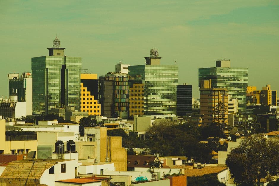 Aerial view of a modern cityscape with tall buildings and urban skyline.