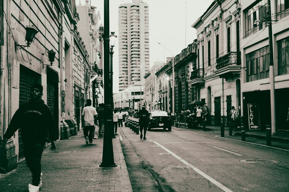 Street view showcasing historic buildings and people walking in a city setting.