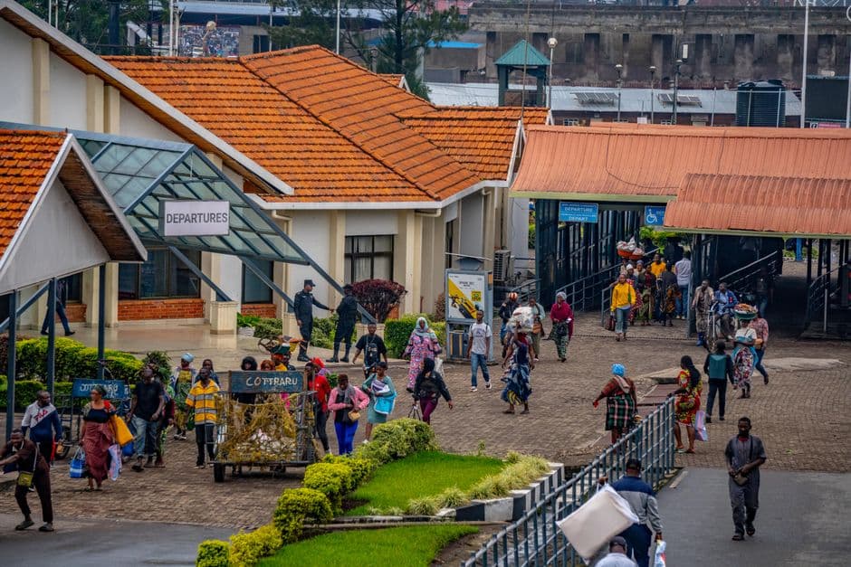 Vibrant African bus terminal bustling with people heading to departures, showcasing daily commute lifestyle.