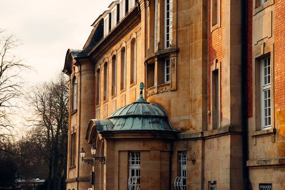 A classic European building with elegant architecture captured in warm sunset light.