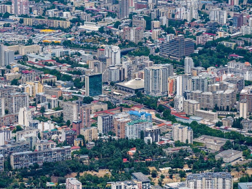 A stunning aerial view showcasing the urban sprawl of Tbilisi, Georgia, with diverse architecture.