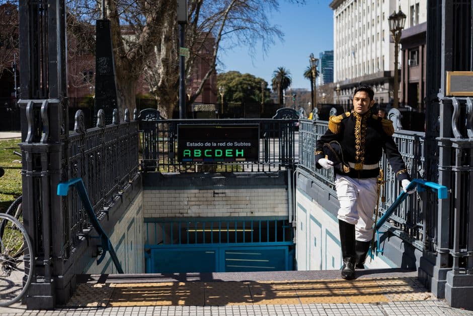 Man in historical uniform exiting subway in Buenos Aires, Argentina, on a sunny day.