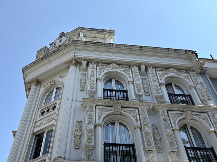 Detailed view of an ornate historic building facade in Istanbul under clear blue sky.