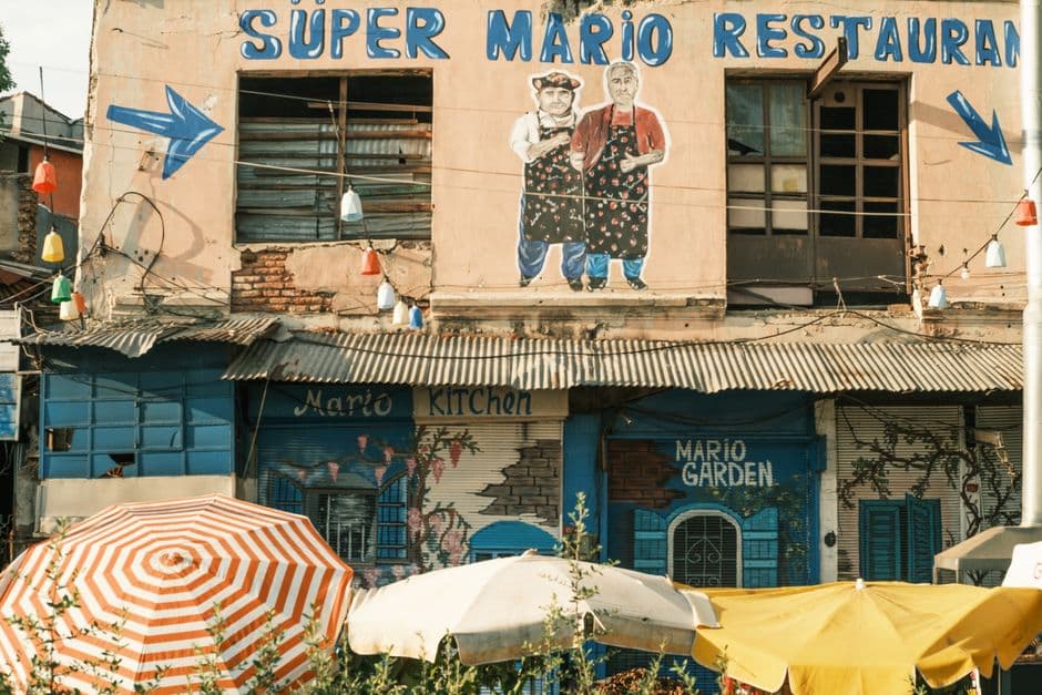 Charming street scene featuring the colorful facade of Super Mario Restaurant in Istanbul, Turkey.
