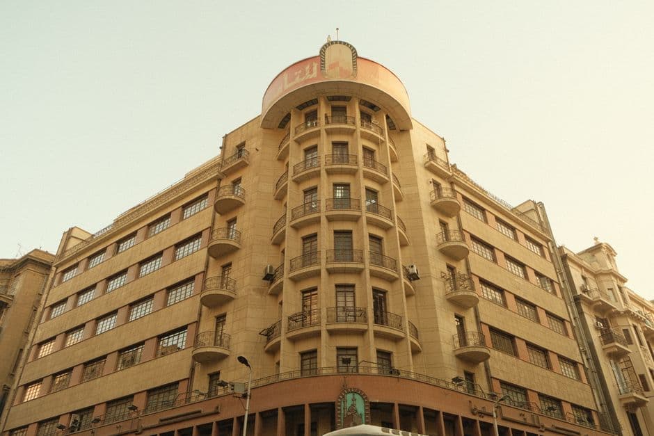 A detailed view of a vintage multi-story building with unique architecture.