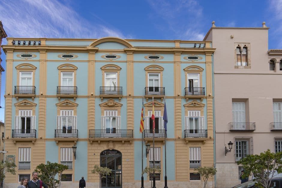 Beautiful neoclassical building in Valencia, Spain with blue sky backdrop.