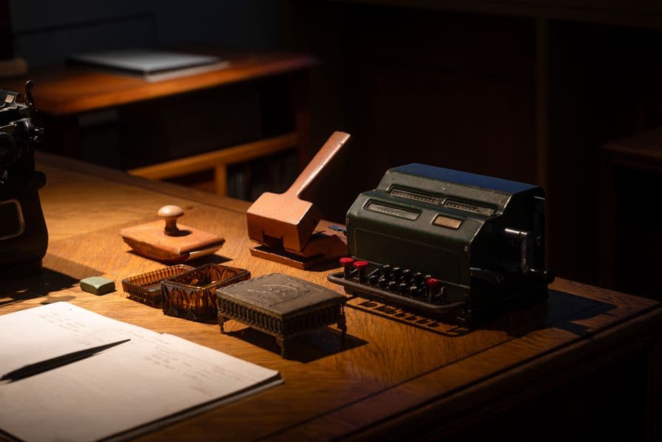 A vintage office desk showcasing a retro calculator and assorted vintage desk tools, perfect for nostalgia and retro themes.