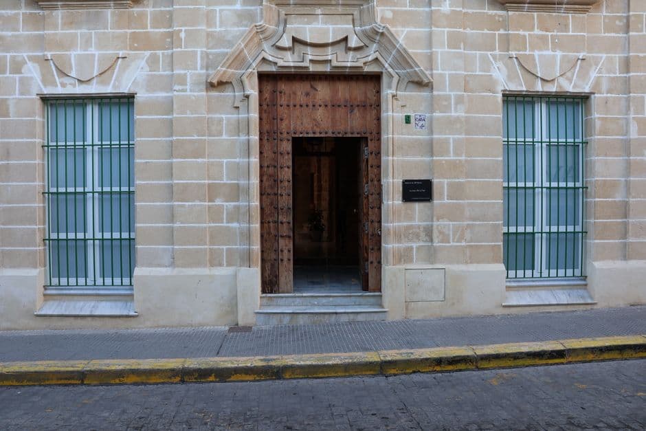 Explore the architectural details of a historic building entrance in El Puerto de Santa María, Spain.