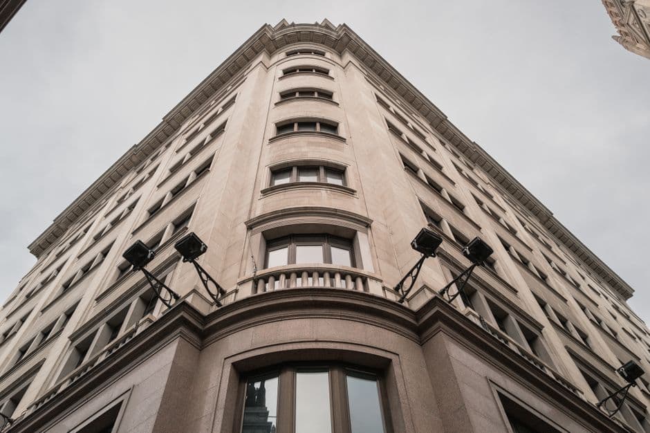 Low-angle view of a classic building facade in Madrid, Spain showcasing urban architecture.