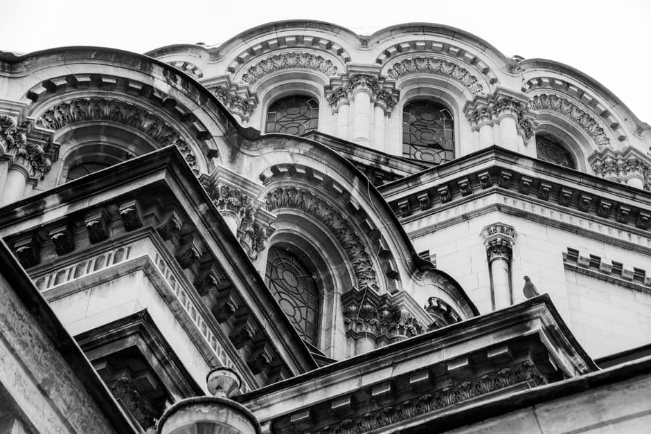 Black and white photo of intricate architectural details on a historic building facade.
