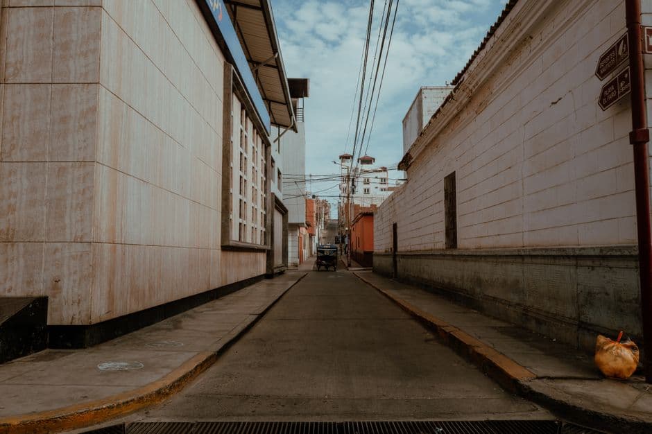 A serene, empty street in Pacasmayo, Peru, showcasing local architecture on a clear day.