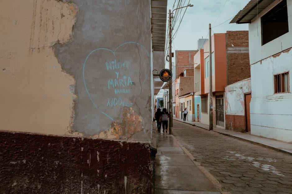 A street scene in Pacasmayo showcasing colorful Peruvian architecture and street art.