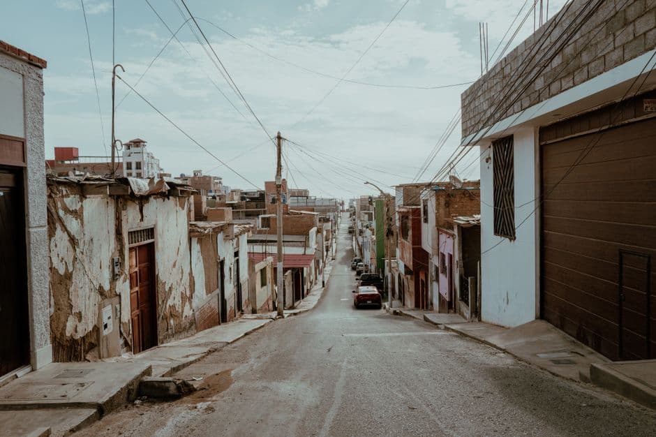 A tranquil street in Pacasmayo, Peru showcasing rustic architecture and a serene atmosphere.