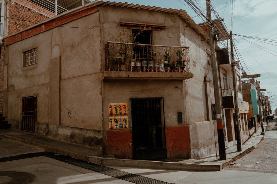 Charming corner building with rustic architecture in Pacasmayo, Peru, capturing urban life.