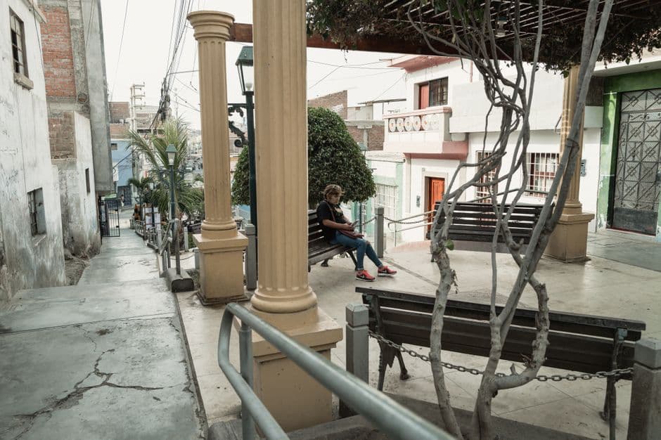 A peaceful moment captured on a quiet street in Pacasmayo, Peru, showcasing local architecture and daily life.