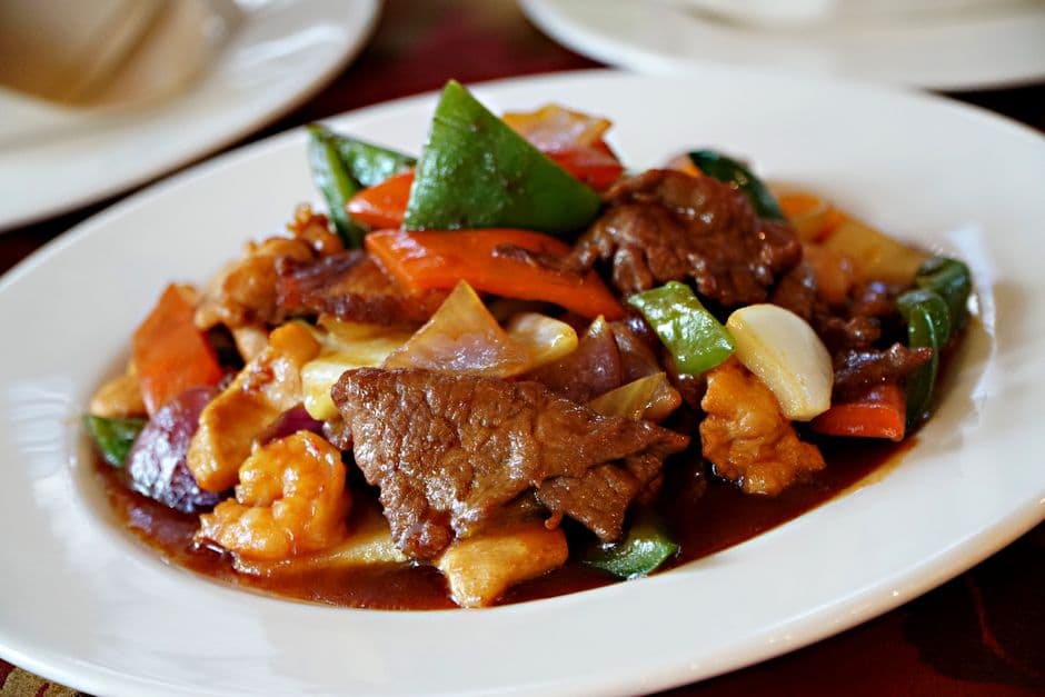 Delicious beef stir fry with colorful vegetables served on a stylish white plate.
